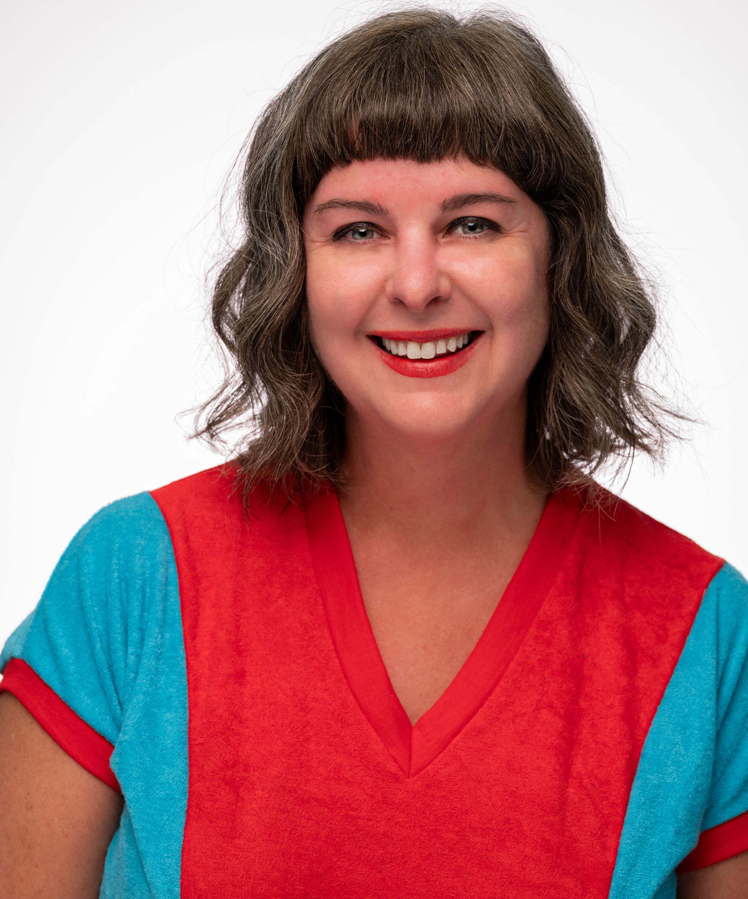 Heidi in teal and tomato red shirt