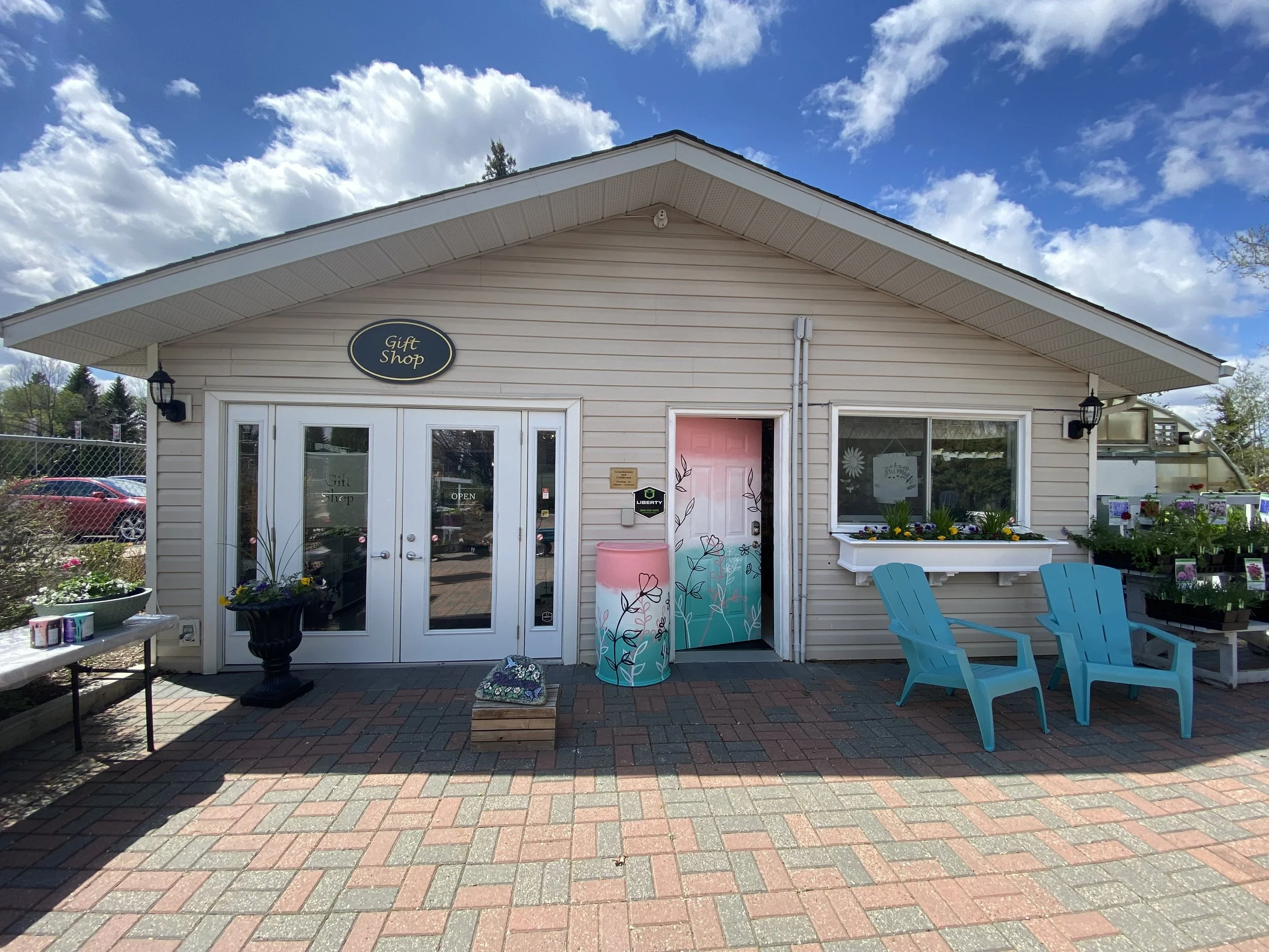 St.Albert Botanical Garden featuring a custom paint job on the front door and rain barrel. Custom paint job by Edmonton, AB artist Carly Marie Murals showcasing the botanical gardens colours and brand