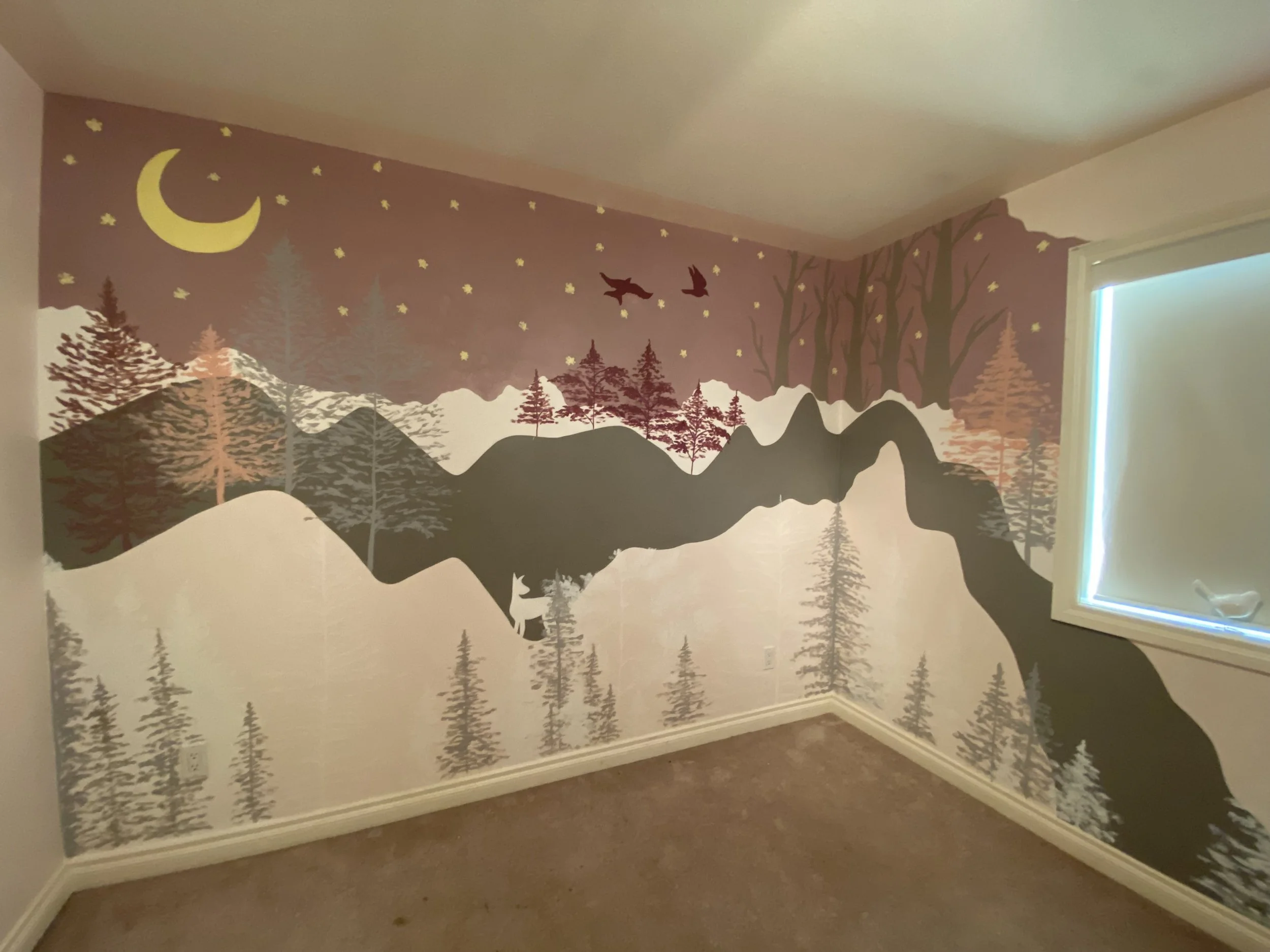 A children's kids bedroom for a girls room featuring nature scene in purples painted on a wall and corner wall depicting mountains, trees, a moon, stars, and flying birds.  Mural painted by Edmonton, AB artist Carly Marie Murals