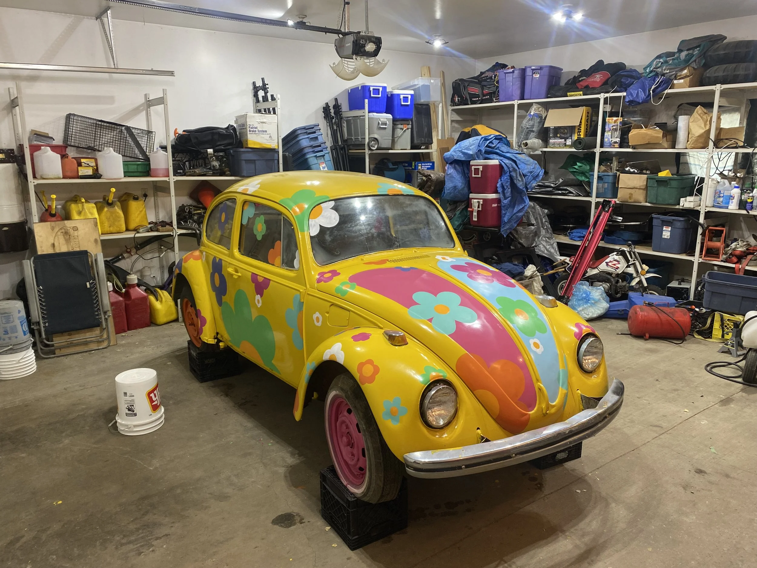 Yellow Volkswagen Beetle hand painted yellow with 70s inspired flowers