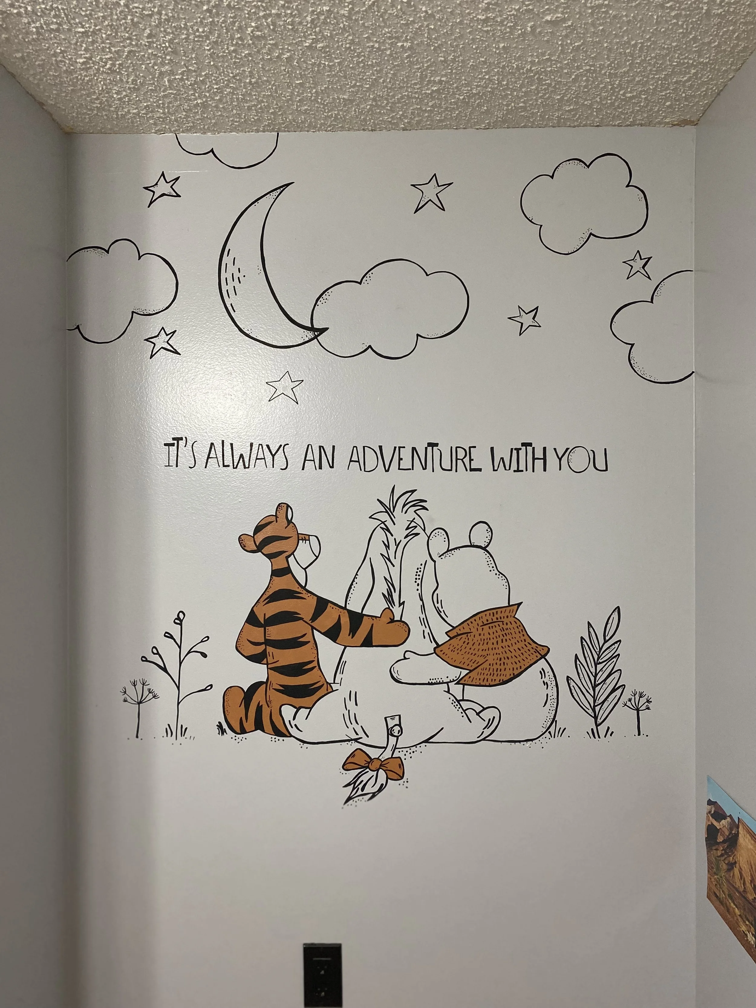 Wall art mural featuring Winnie the Pooh and Tigger sitting on a large honey pot surrounded by plants and trees, with a quote that says 'It's always an adventure with you'. by Edmonton, AB artist Carly Marie Murals