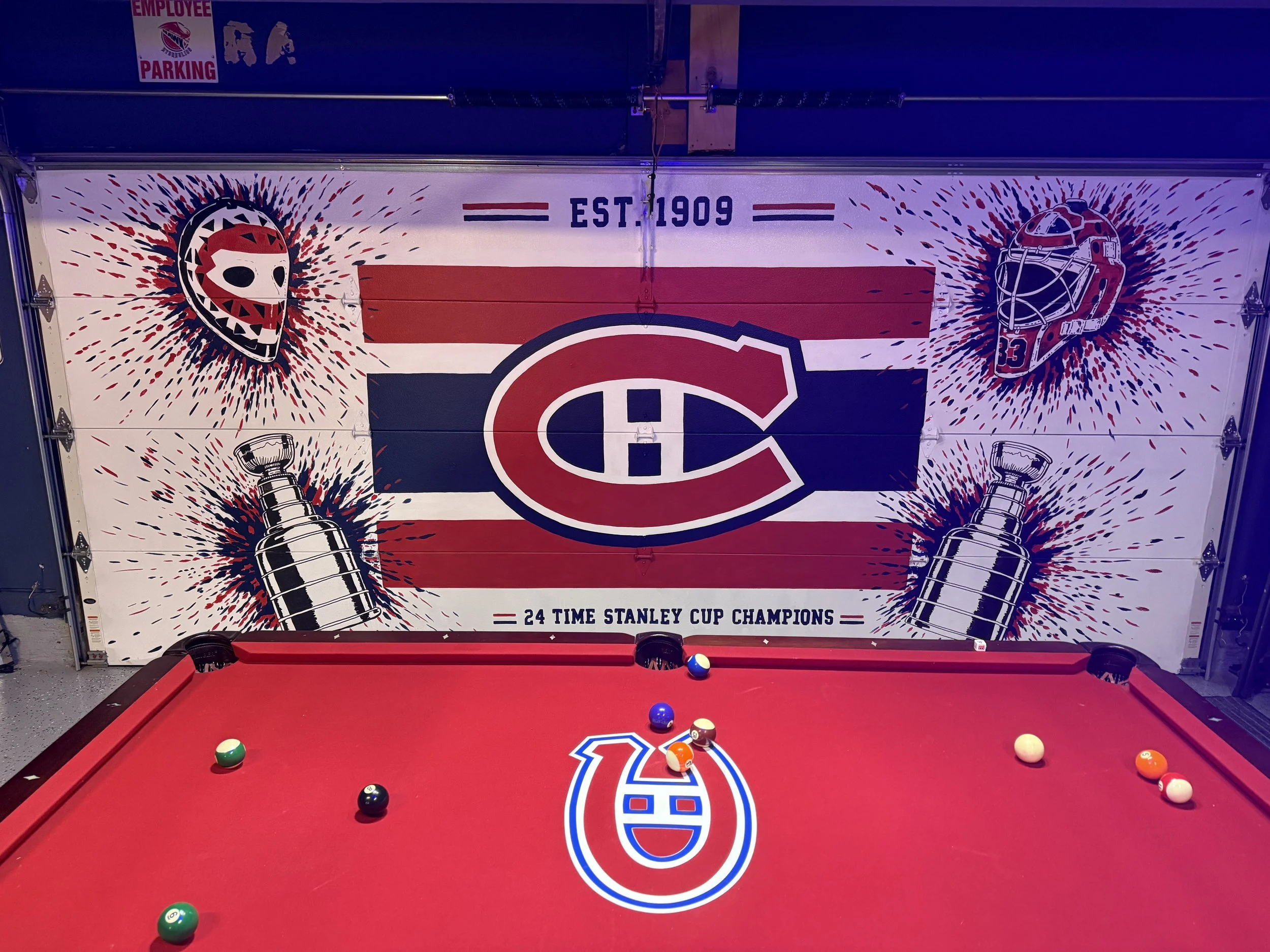 Man Cave garage mural featuring Montreal Canadiens logo, Patrick Roy goalie masks, Stanley Cups and "24 Time Stanley Cup Champions. painted on garage door by Edmonton, AB artist Carly Marie Murals