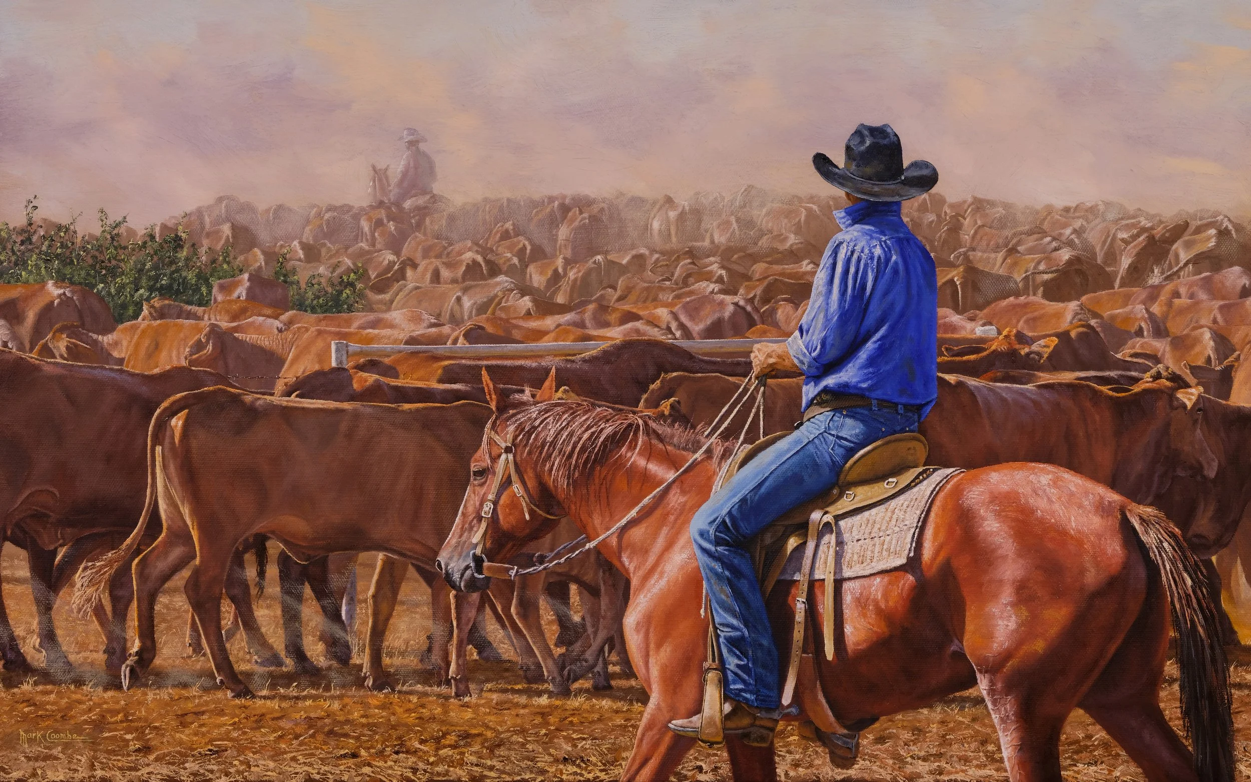 A cowboy riding a horse through a herd of cattle with another cowboy on horseback in the background.
