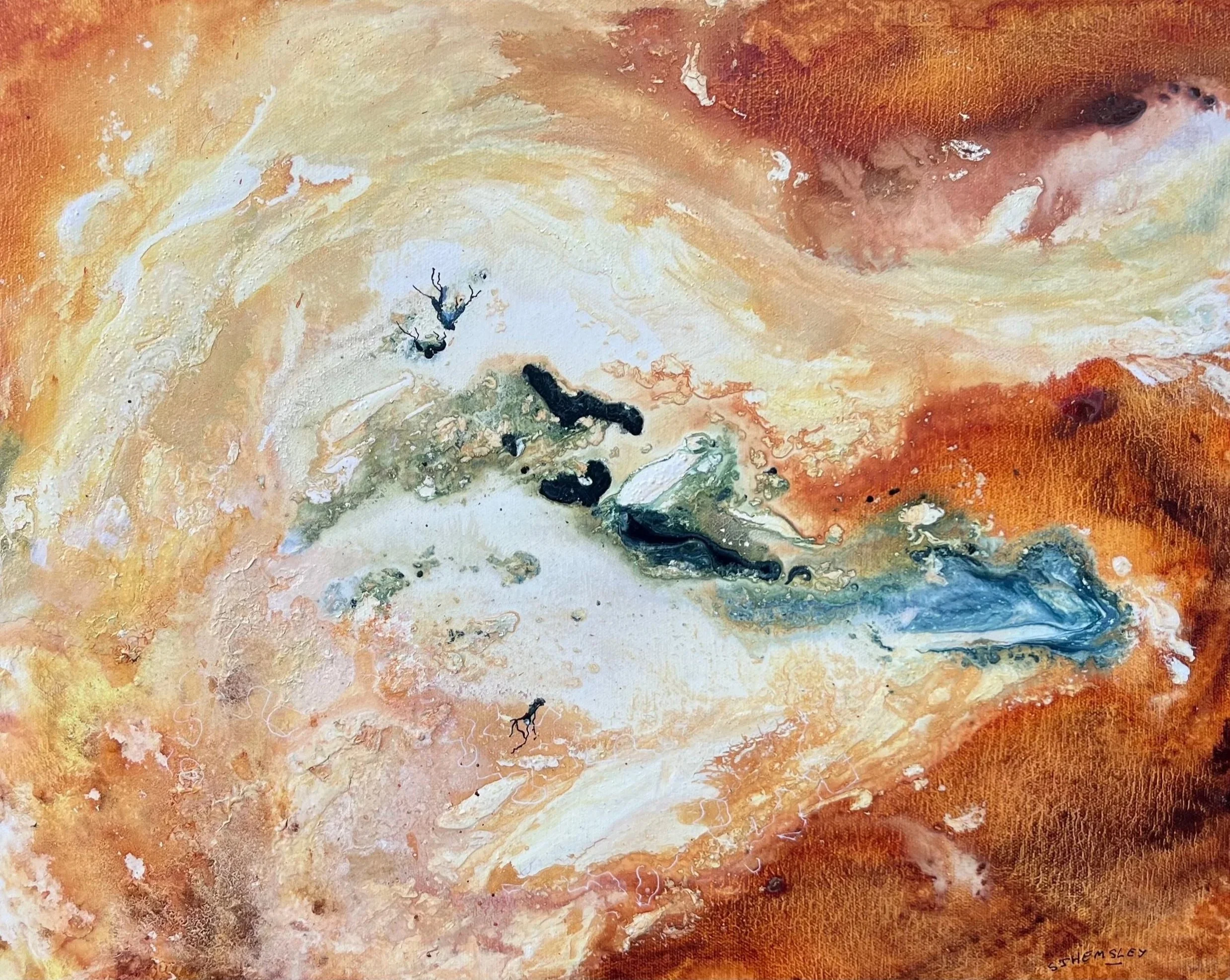 Close-up of an abstract painting with swirling orange, yellow, and white colors, textured with visible brushstrokes and small dark patches. The artist's signature, 'S. THEMSLEY,' is visible in the bottom right corner.
