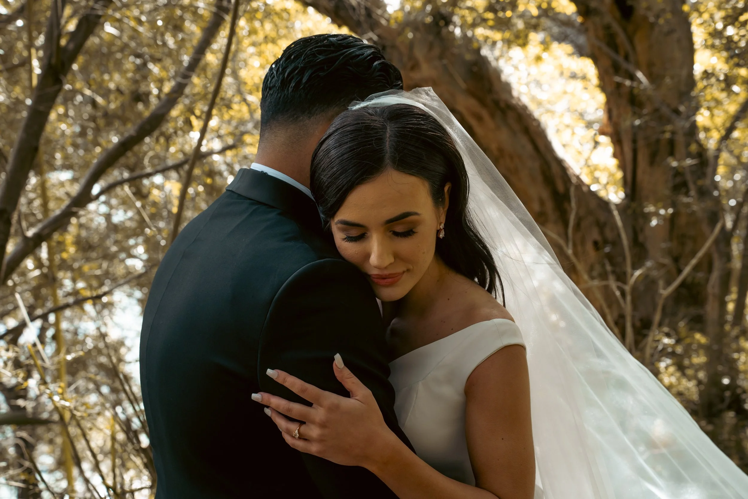 A photo of a bride and groom hugging and being in love