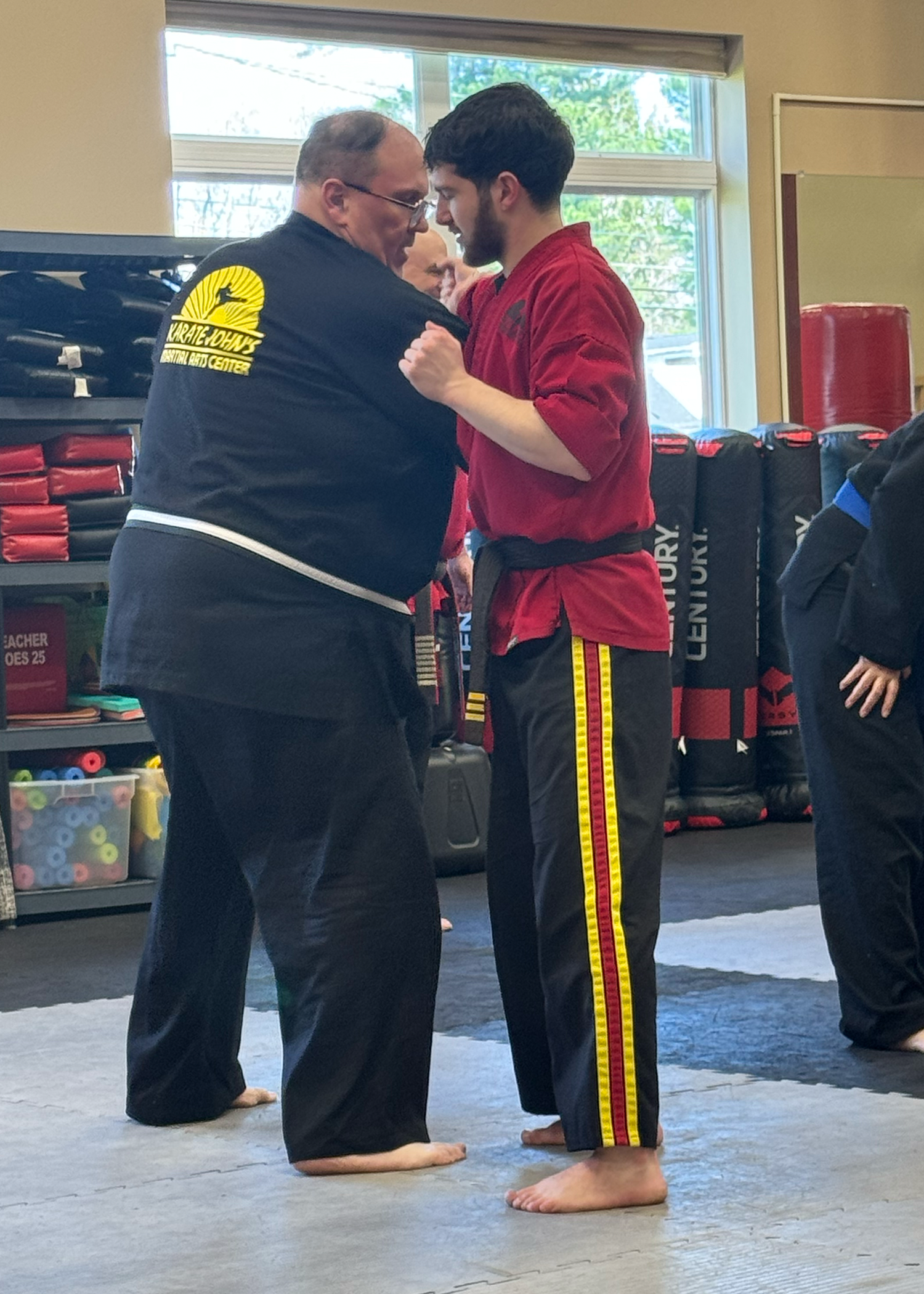 Woman showing weigh loss by training self-defense at Karate John's Martial Arts centers in Cicero, NY and Liverpool, NY.