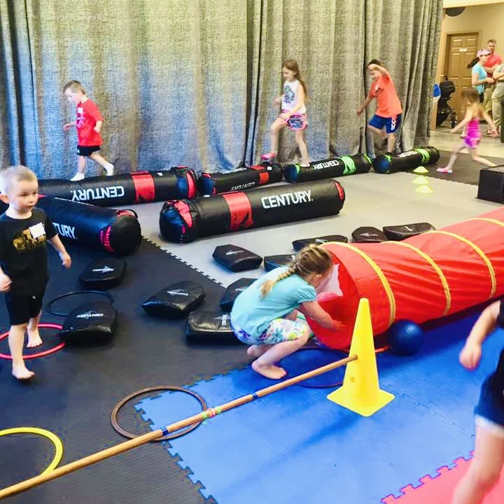 Group of kids making goofy faces during birthday party obstacle course at Karate John's in Cicero and Liverpool, NY.