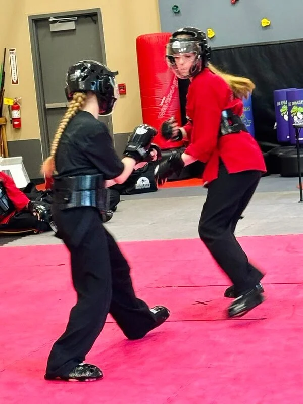 Teen students practicing controlled karate sparring at Karate John’s Martial Arts Center in Cicero and Liverpool, NY, building confidence, self-defense skills, discipline and sportsmanship in a safe environment.