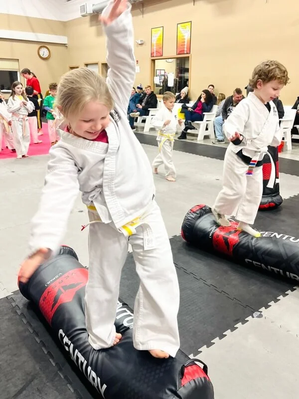 Child clearing obstacle course during balance and coordination practice in Karate John's Martial Arts in Cicero, Liverpool, NY.