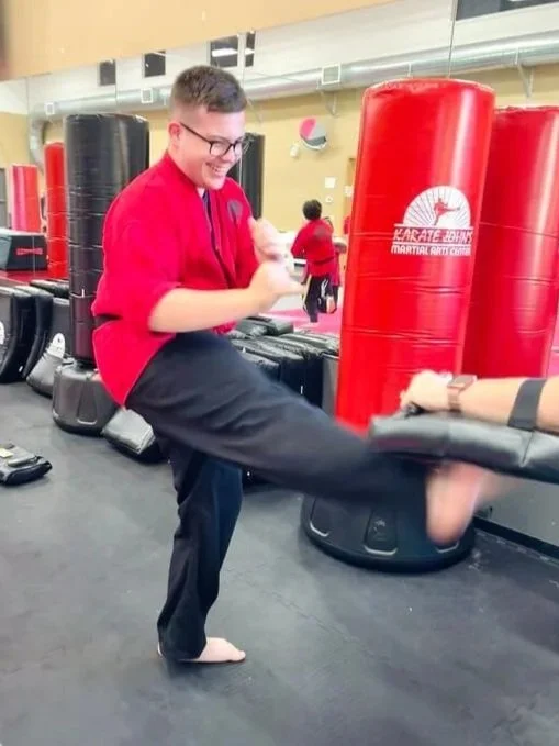 Teen student practicing a karate front kick during martial arts training at Karate John’s Martial Arts Center in Cicero and Liverpool, NY, developing confidence, discipline, fitness and practical self-defense skills.