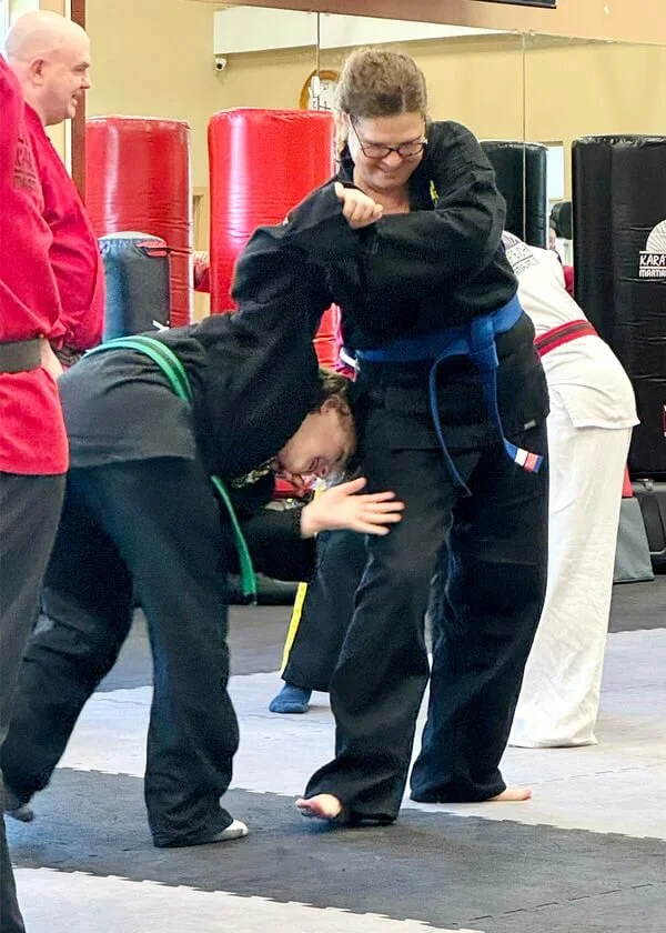 Adults practicing practical self-defense techniques during a martial arts class at Karate John’s Martial Arts Center in Cicero and Liverpool, NY.