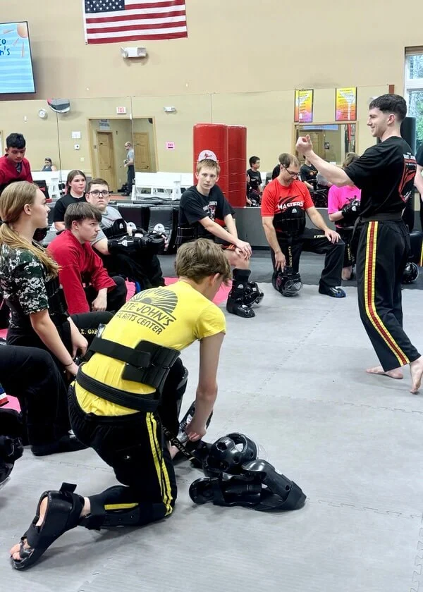 Karate instructor coaching teen and adult students during martial arts training at Karate John’s Martial Arts Center in Cicero and Liverpool, NY.