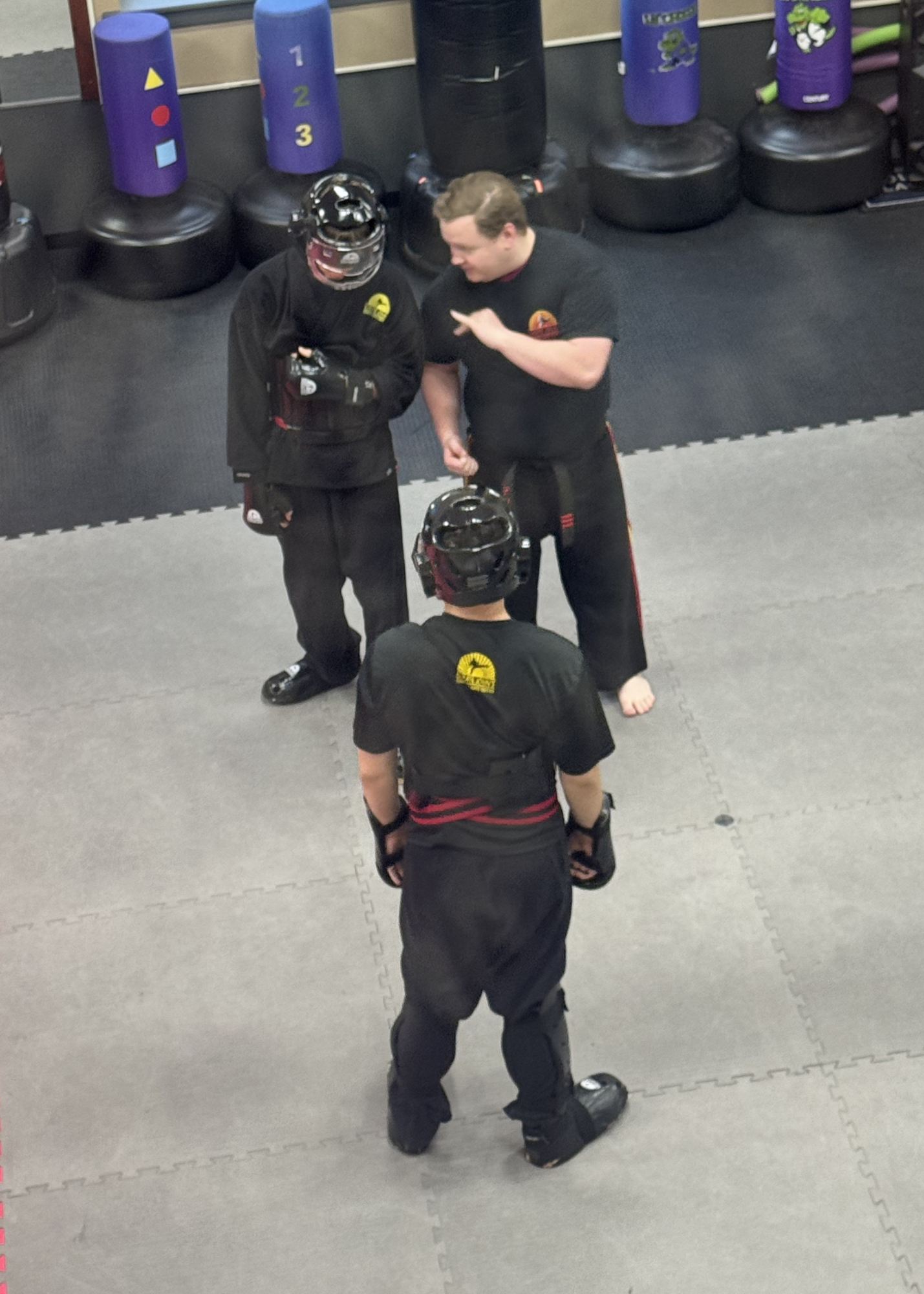 Adult student punching a hand pad in a martial arts and self-defense class at Karate John's Martial Arts center in Cicero and Liverpool, NY.