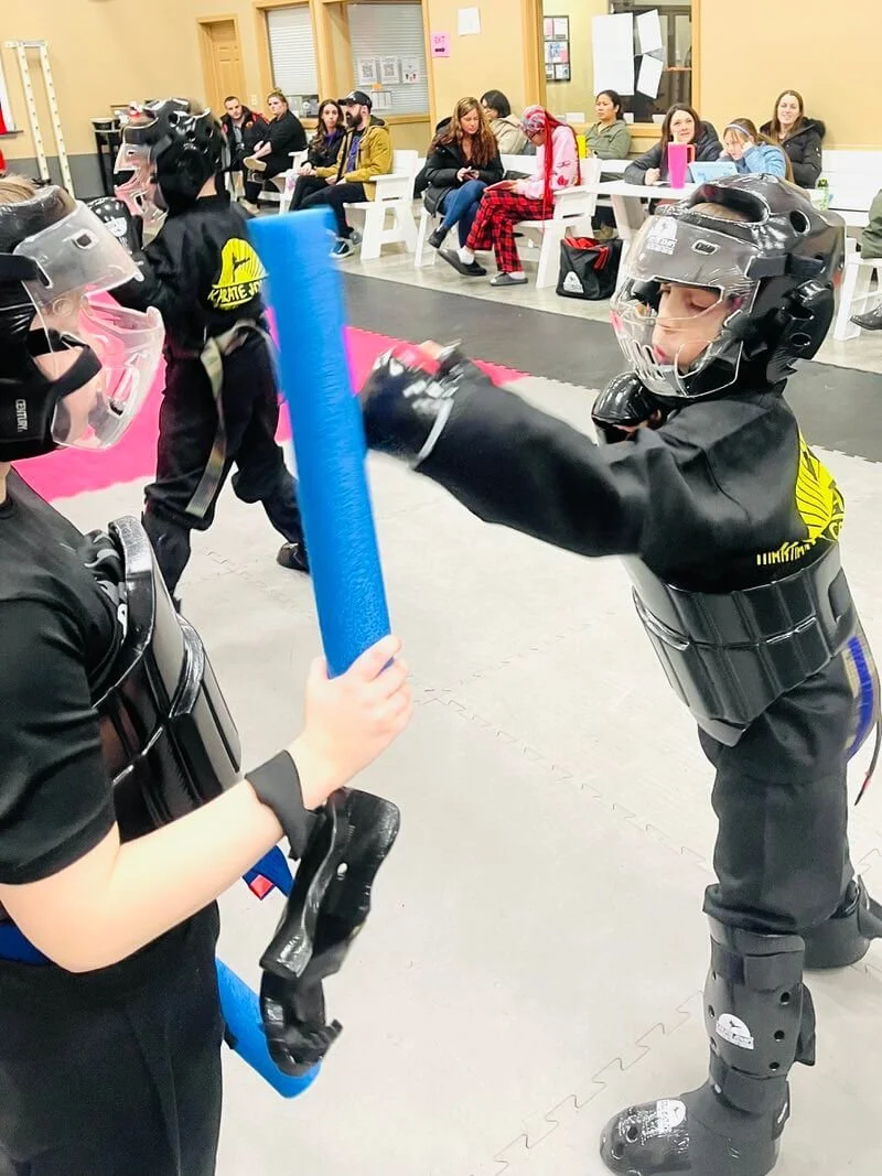 Kids practicing save sparring and self-defense in martial arts class in Cicero Liverpool, New York.
