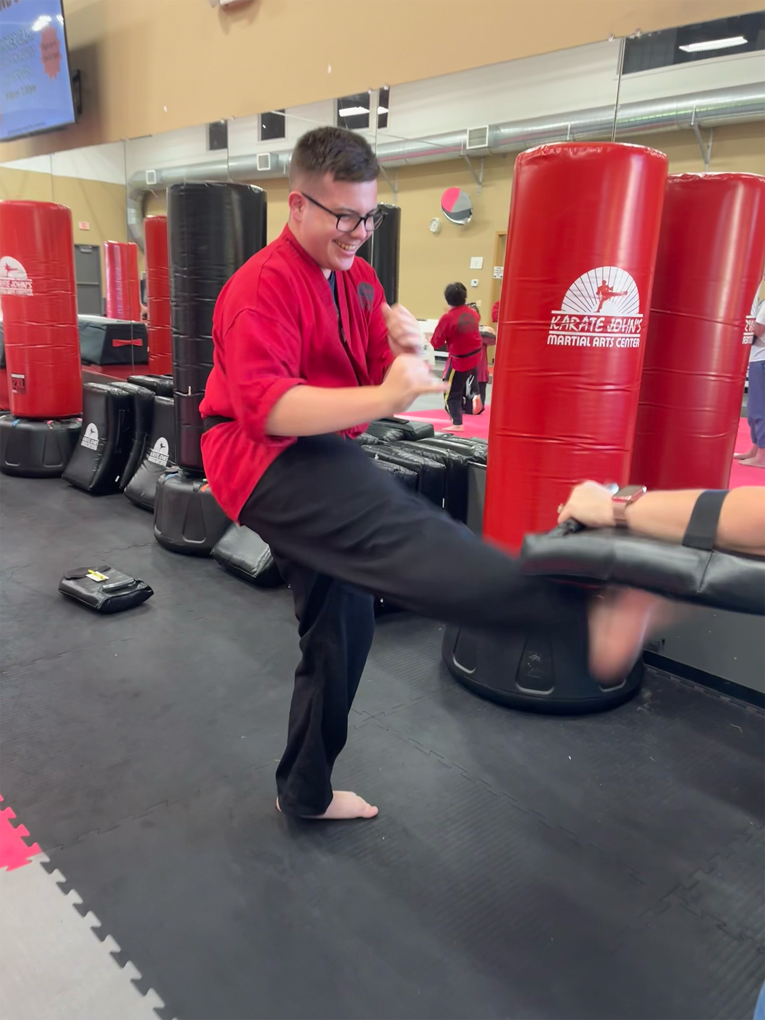Teen girl kicking high in a martial arts and kenpo karate class in Cicero, NY and Liverpool, NY.