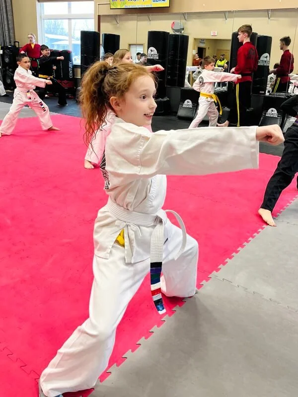 Girl punching in a horse stance during martial arts practice in Cicero, Liverpool, NY.