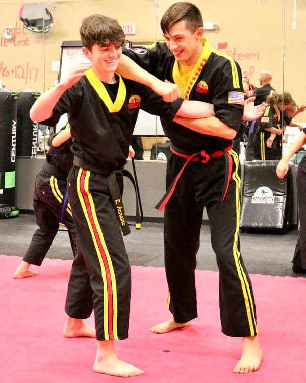 Two boys practicing self-defense in a self-defense class at Karate John's Martial Arts in Cicero and Liverpool, NY.