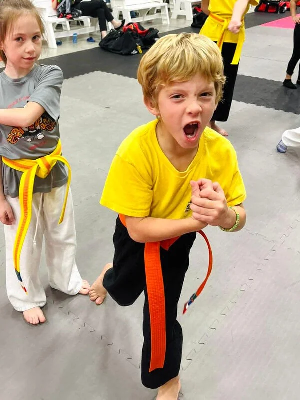 Confident boy yelling victoriously a karate class in Cicero and Liverpool, NY.