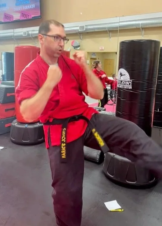 Adult practicing karate kicks to improve flexibility, fitness and self-defense at Karate John’s Martial Arts Center in Cicero and Liverpool, NY.