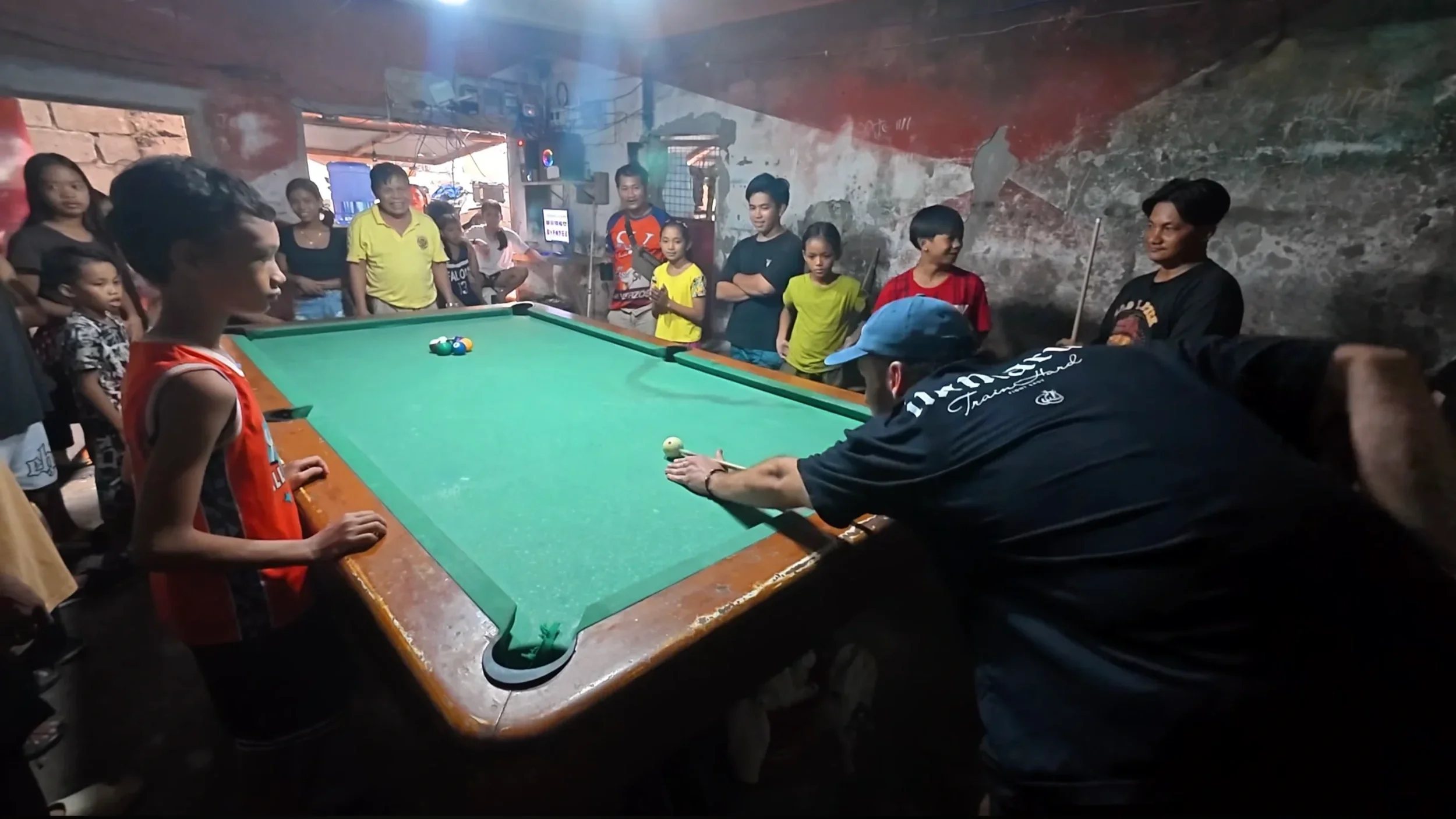 Playing billiards in a Tondo alley with locals