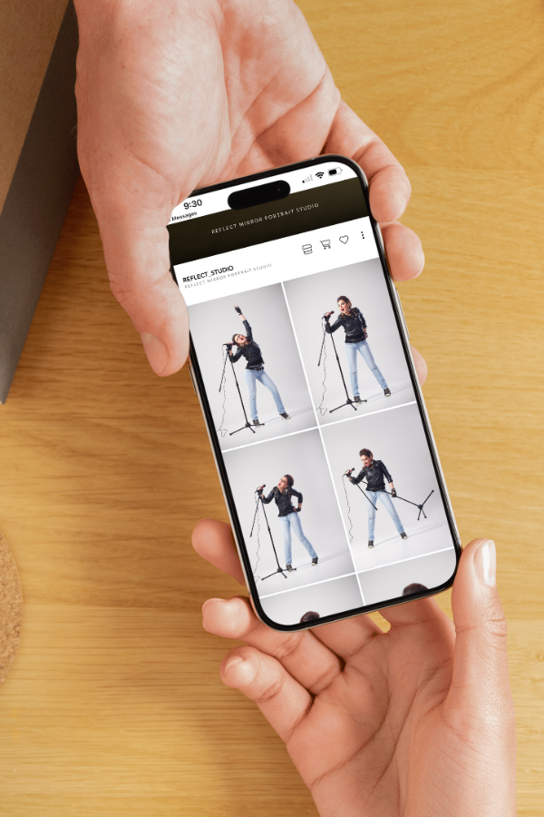Hands pass a phone with a photo gallery on screen.