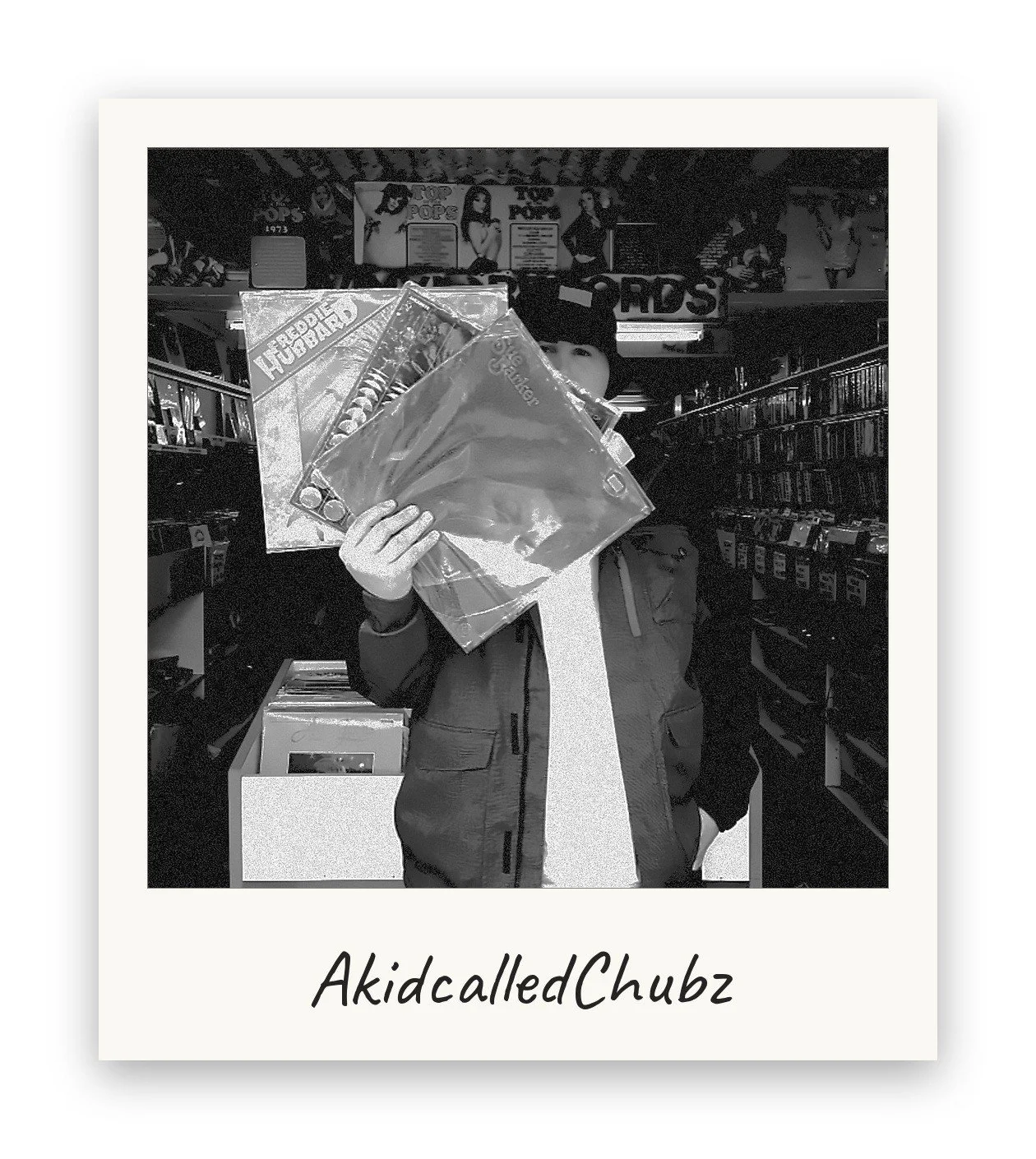 AkidcalledChubz, Milesago co-founder, holding a fan of jazz and soul vinyl records while crate digging in a record shop