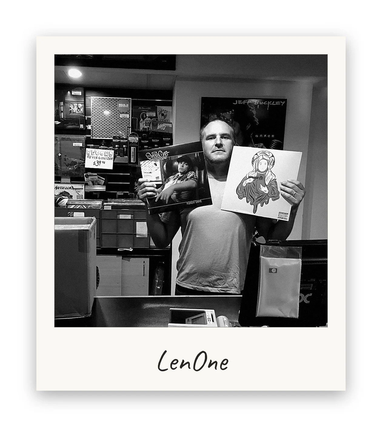 LenOne, Milesago co-founder, holding two vinyl records behind the counter at a record shop