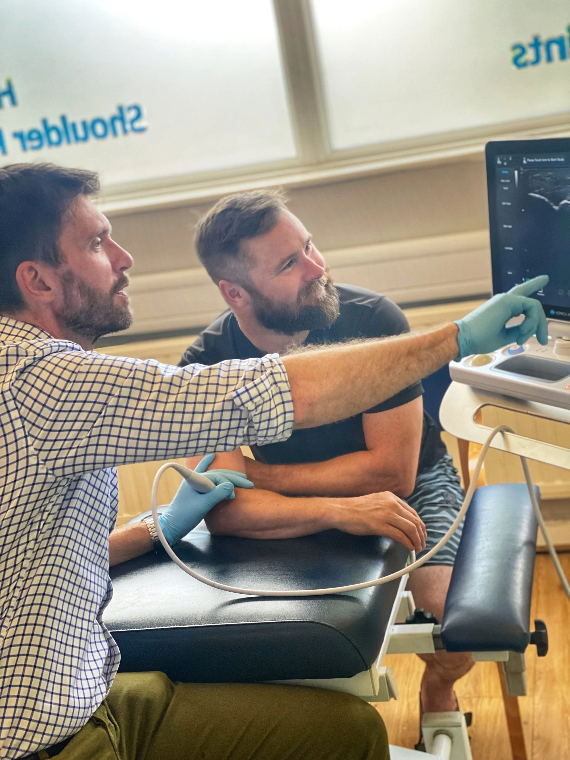 Medical professionals conduct an ultrasound on a male patient at leigh injection clinic.