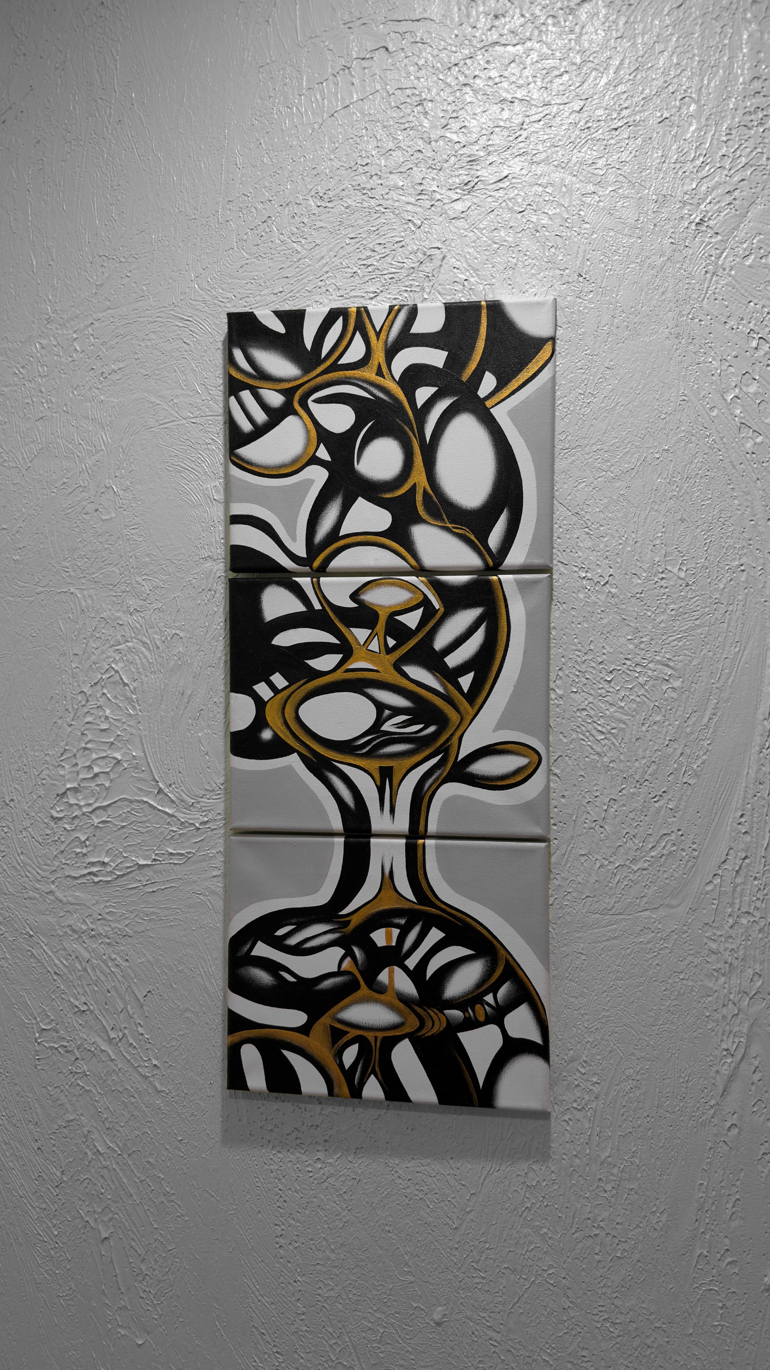 Abstract painting of three different individuals on three canvas panels with black, white, gray, and gold shapes, mounted on a textured white wall.