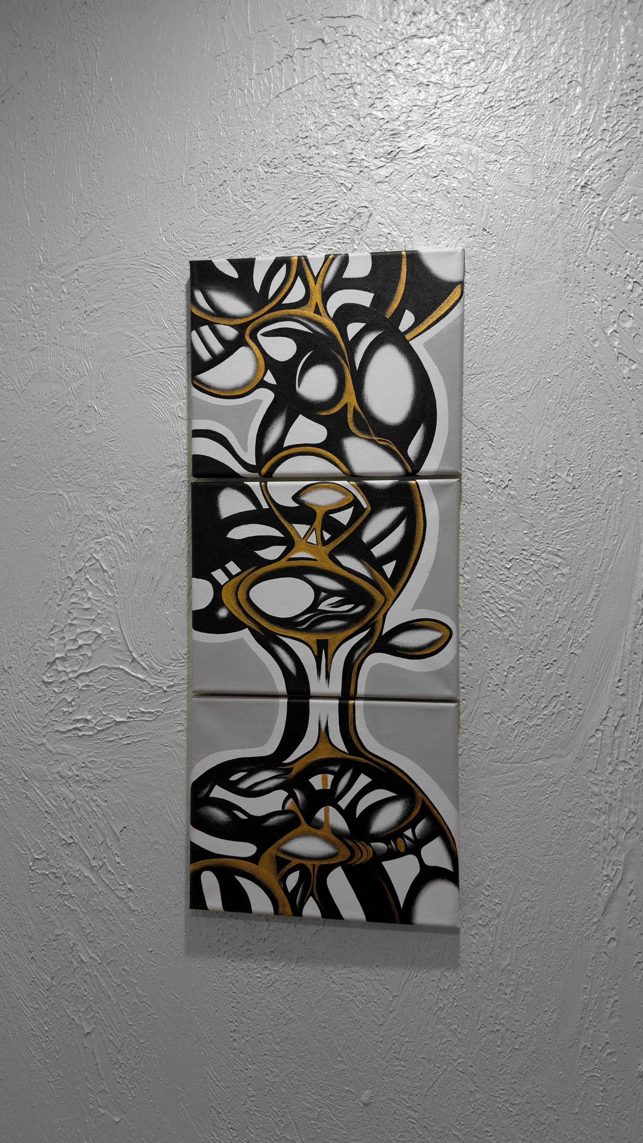 Three vertical panels with a black, white, and gold abstract line drawing of a vase with flowers, mounted on a textured white wall.