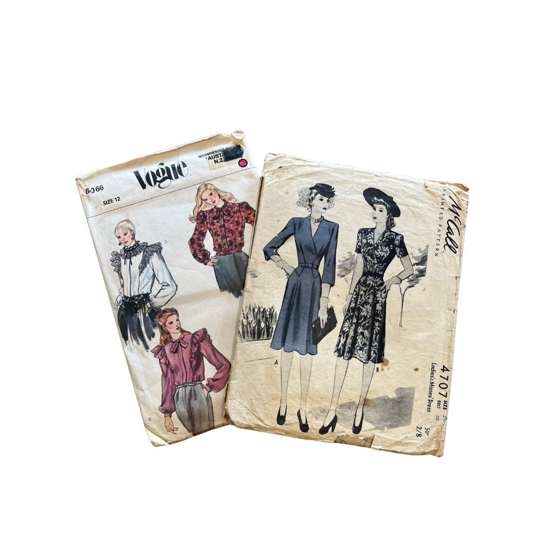Two vintage sewing pattern envelopes with illustrated women's fashion designs from the mid-20th century, featuring dresses and blouses.