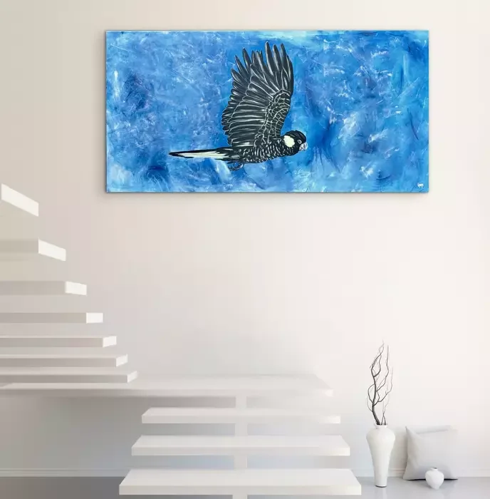 Black cockatoo in blue sky