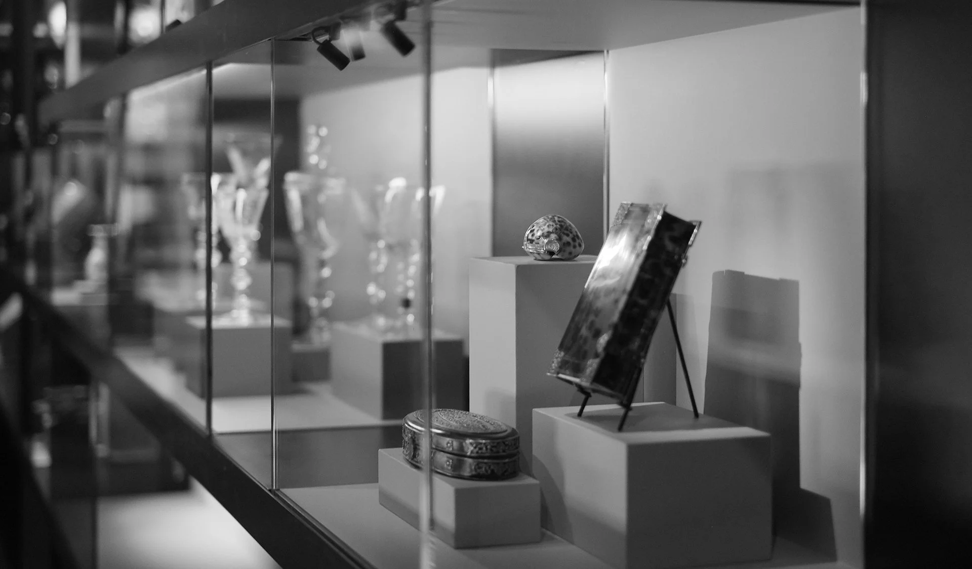 Museum exhibition design and display case with artworks and collection objects.