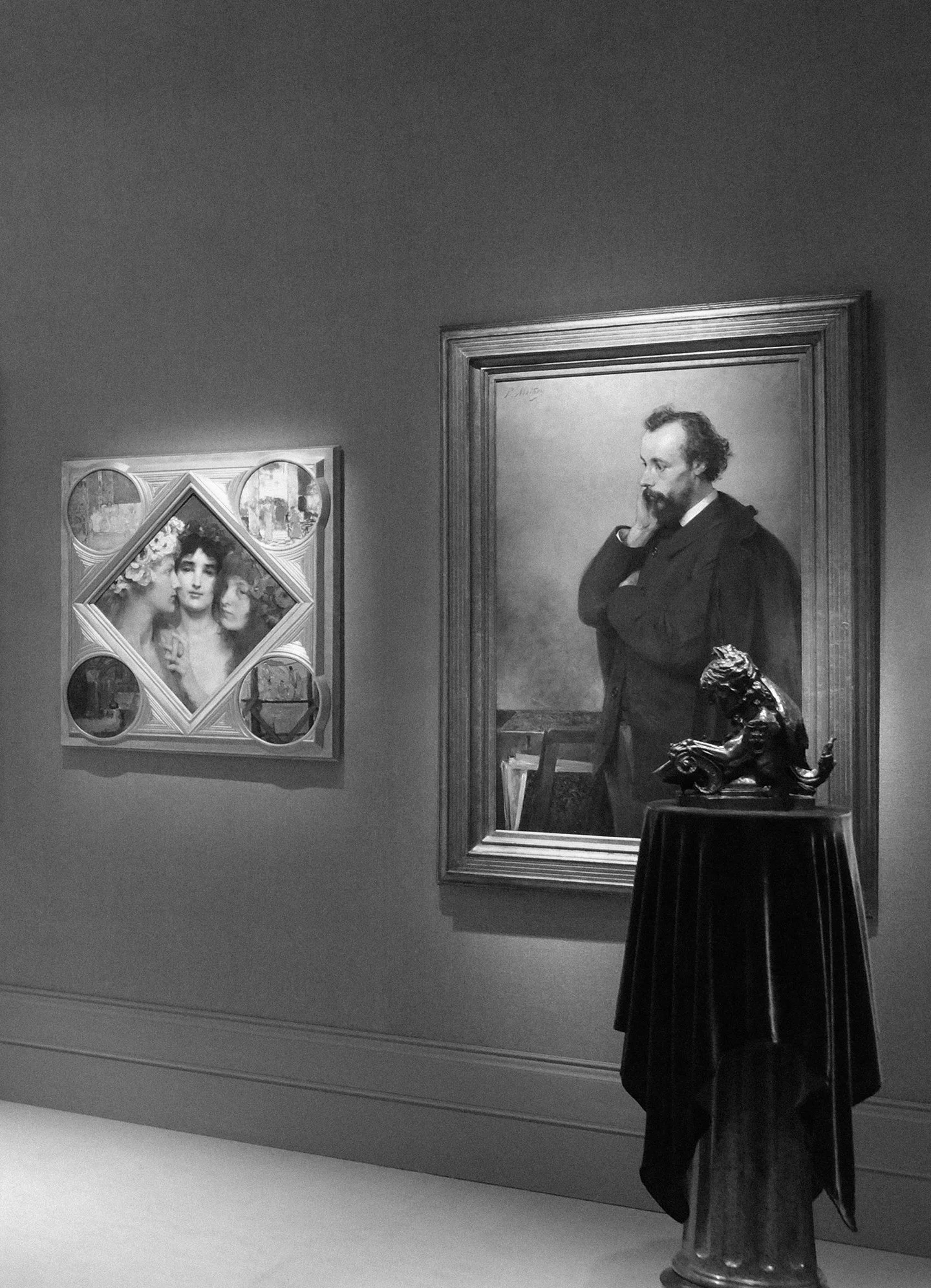 art fair booth gallery interior featuring portrait paintings in ornate frames and sculpture on pedestal