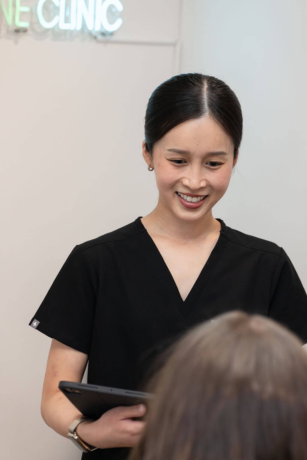 Nurse Tania Nguyen at Define Clinic consulting a patient
