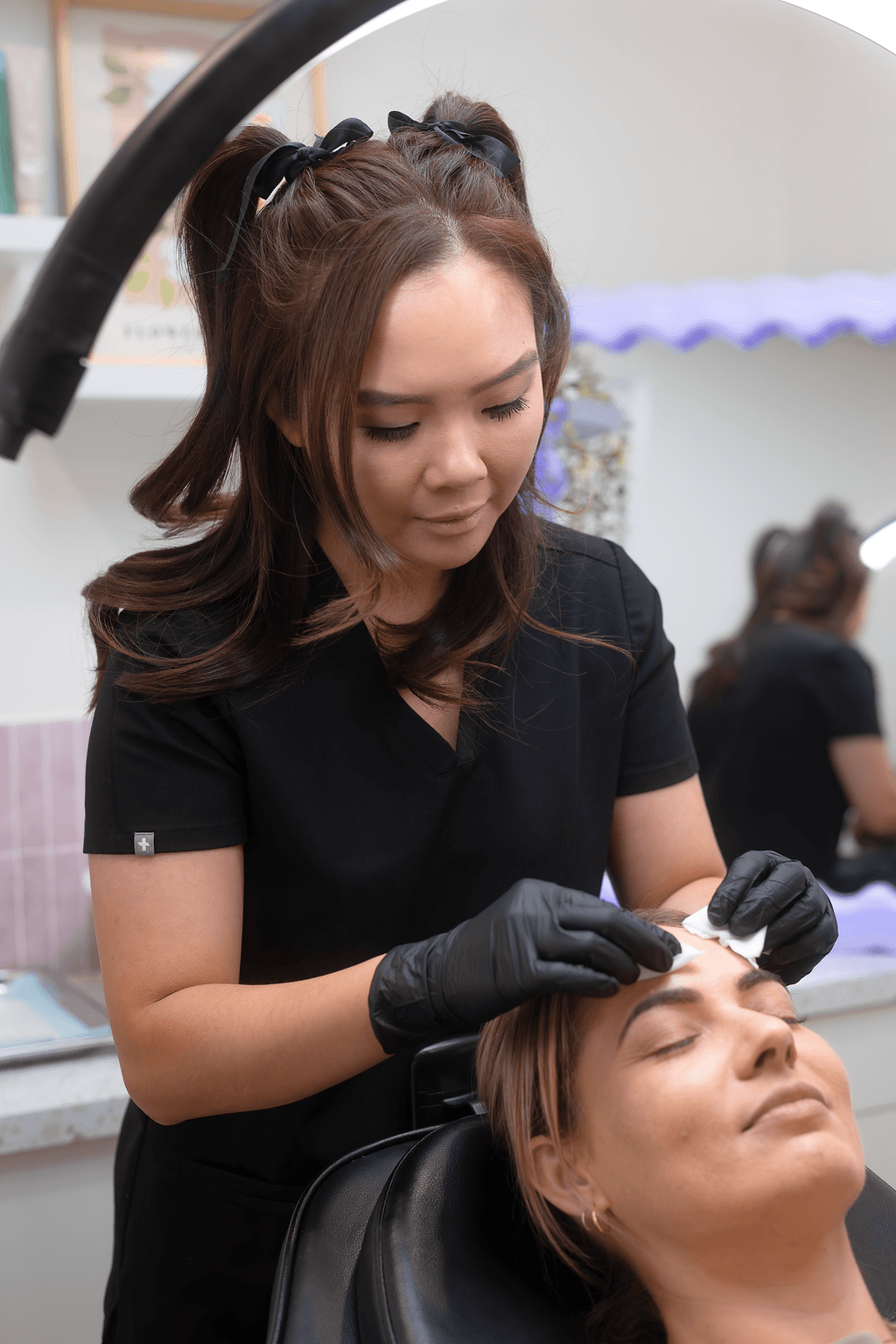 A woman receiving a facial treatment at define clinic.