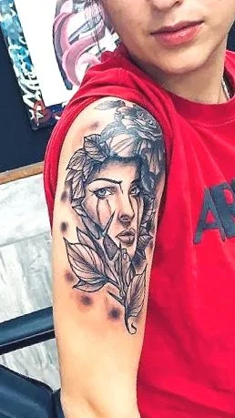 womans mothers portait on girls shoulder tattoo by cabo kidd in a cabo san lucas tattoo shop 