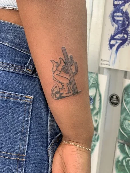 Tattoo of a cactus with a small cactus near it, on the person's forearm.