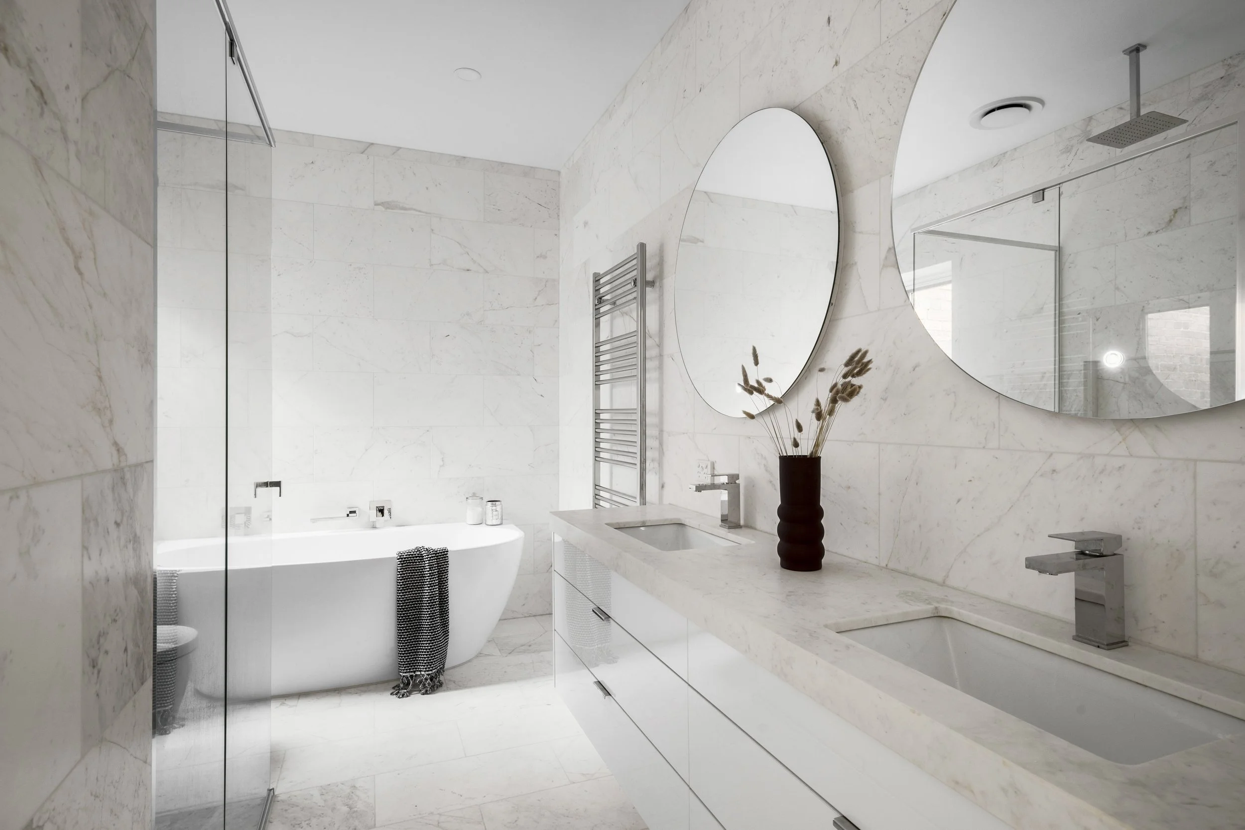 Small bathroom renovation in Fitzroy Melbourne with freestanding bath, marble tiles and custom vanity designed for a compact space.