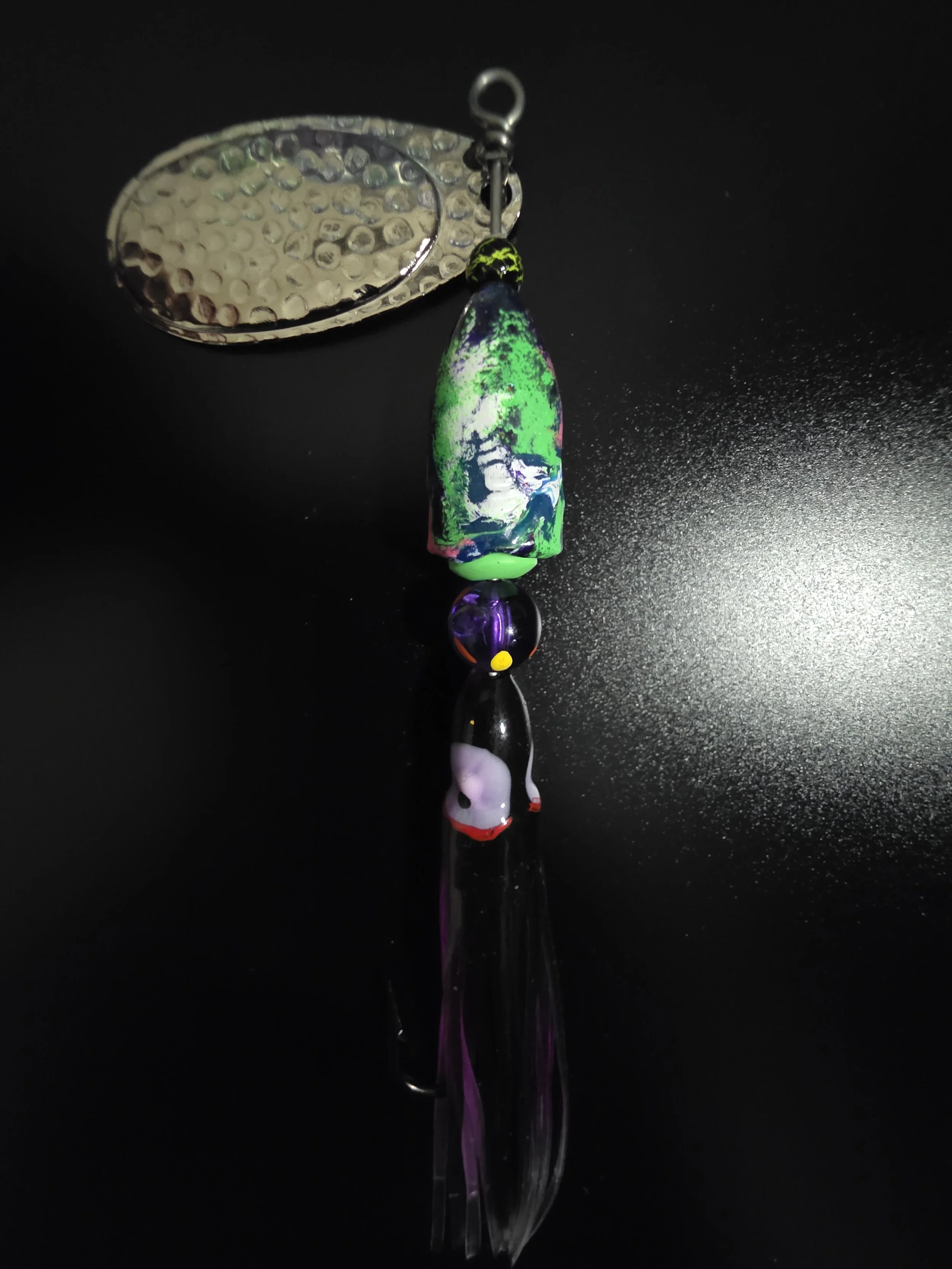 Close-up detail of the hand-painted royal purple, electric violet, and silver flake finish on the KAMAKAZI spinner.