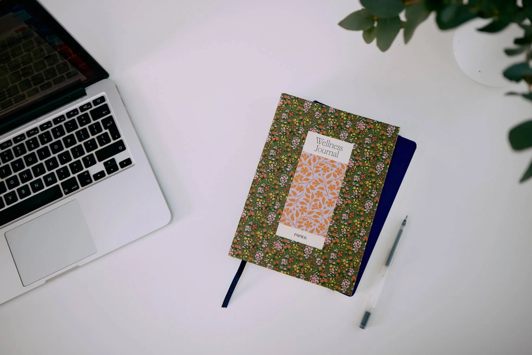 A secure laptop and notebook setup illustrating online therapy sessions for clients in the UK