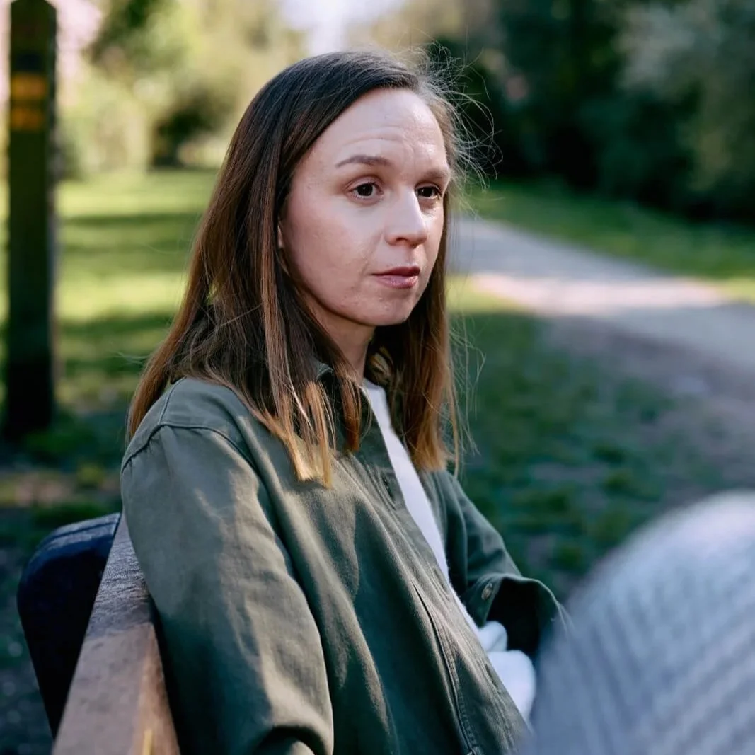 Outdoor psychotherapy session with therapist Ann Moorhouse sitting on a bench in a calm green space in the Rushcliffe area.
