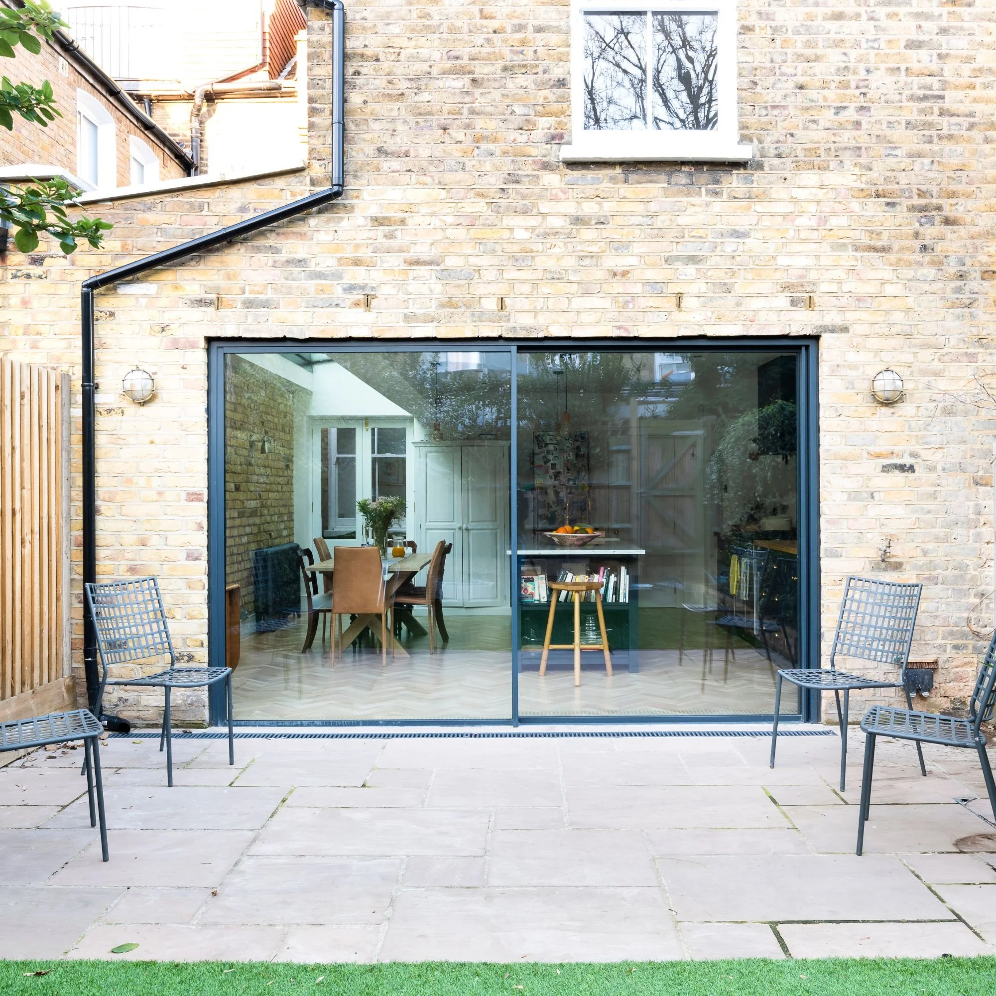 Slimline black sliding patio doors across a modern rear extension in the West Midlands