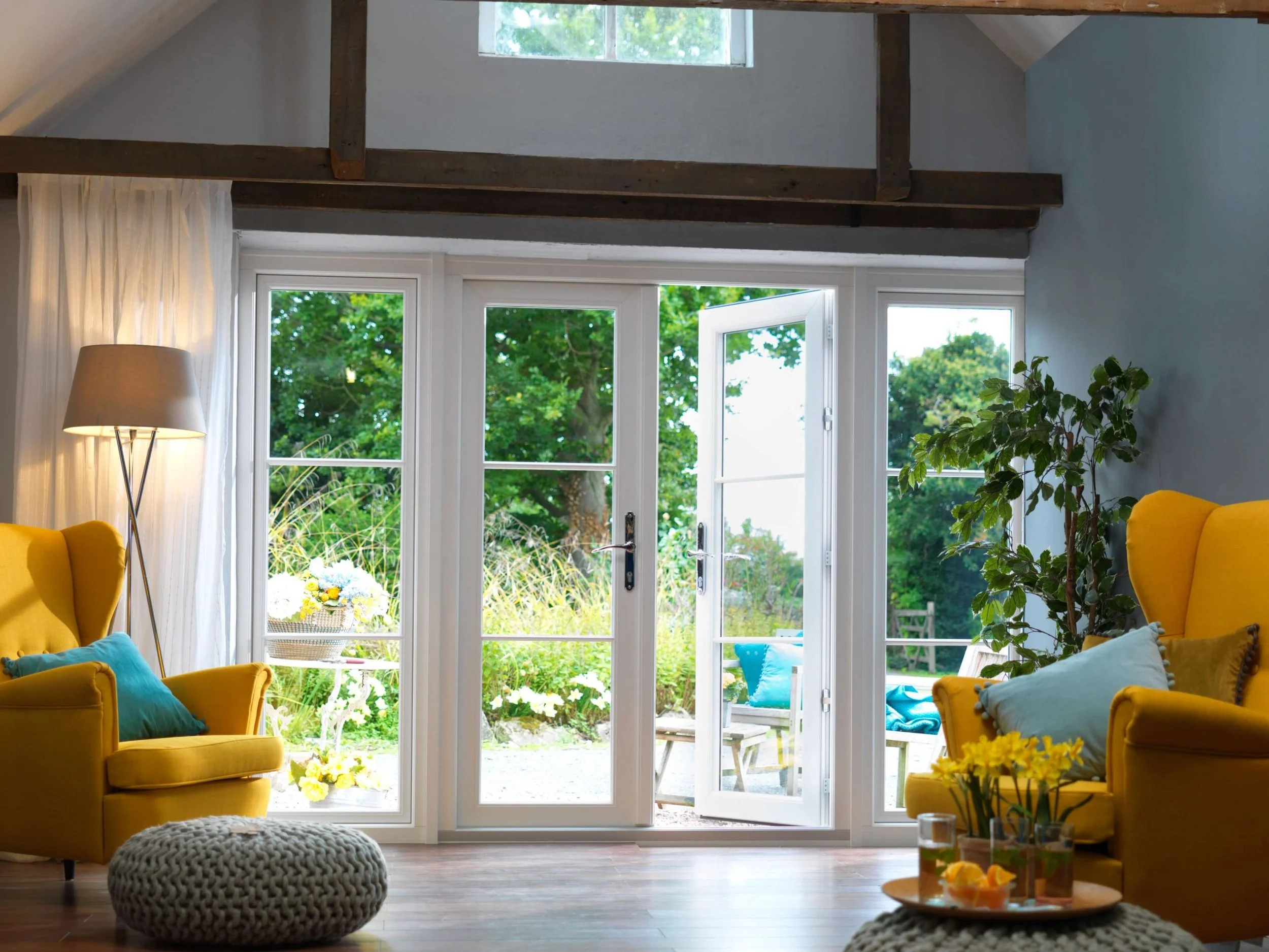 White French patio doors with side panels opening into a bright living room in the West Midlands