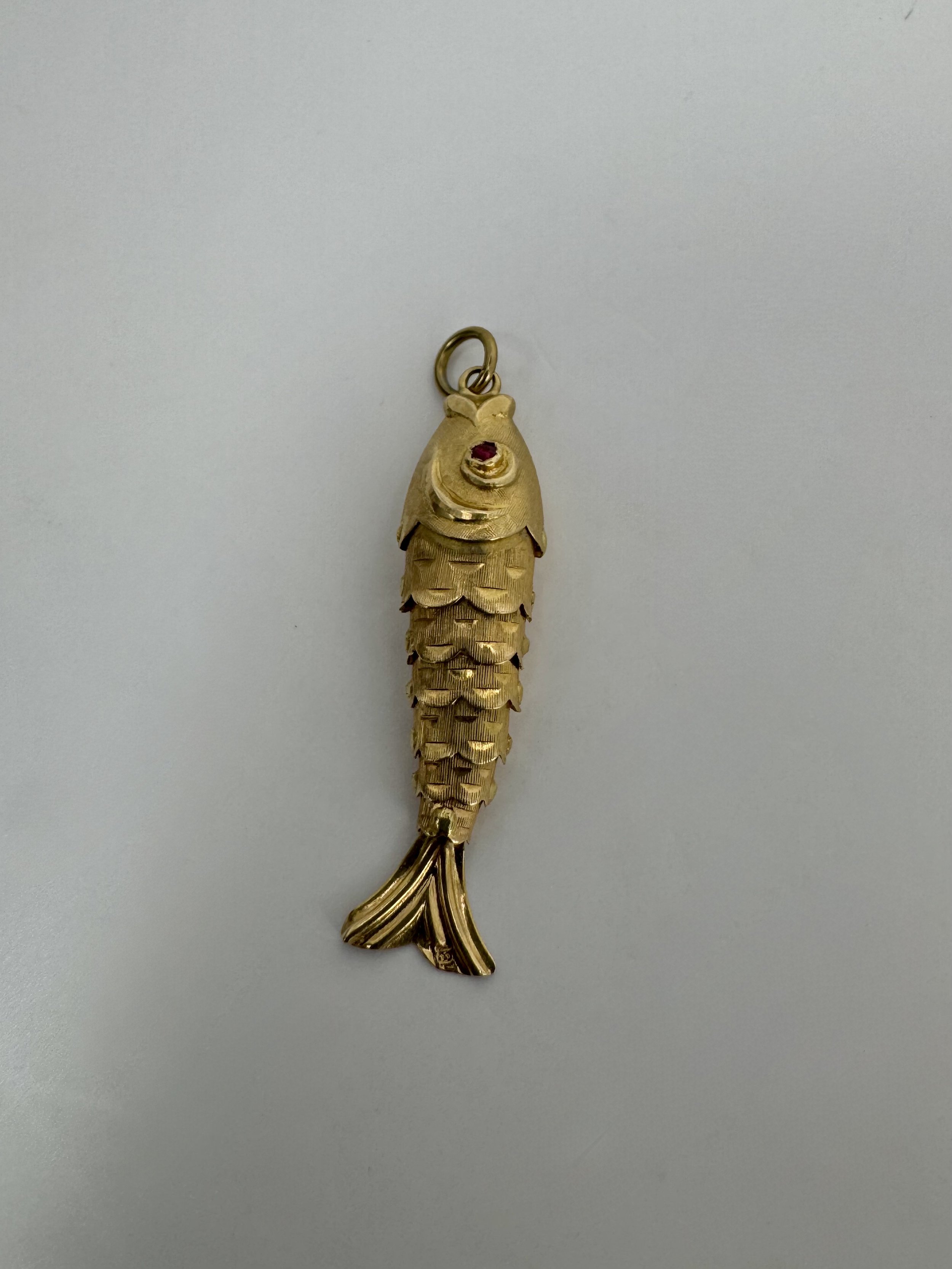 18 carat gold articulated fish charm with ruby