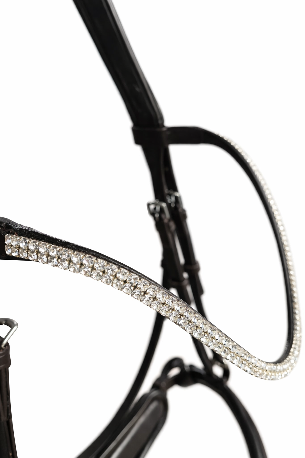 Close up of a clear crystal anatomical browband of a brown leather anatomical bridle 