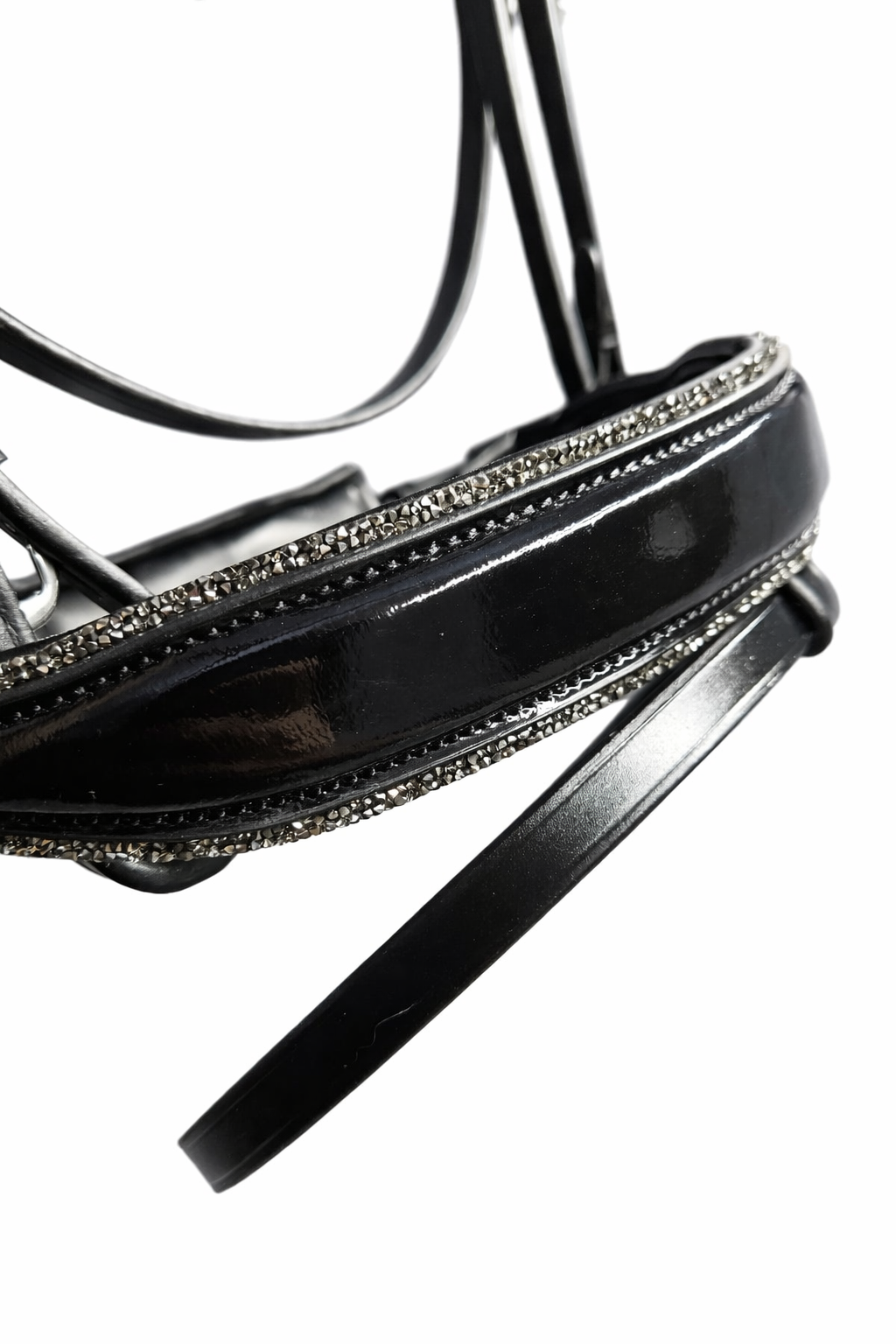 Close-up of a black high-heeled sandal with glittering details along the strap.