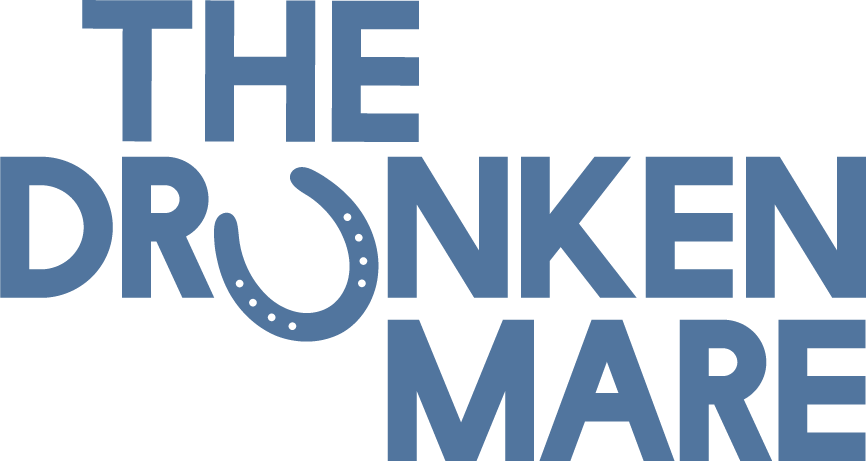 Text graphic reading 'The Drunken Mare' with a horseshoe incorporated into the lettering.