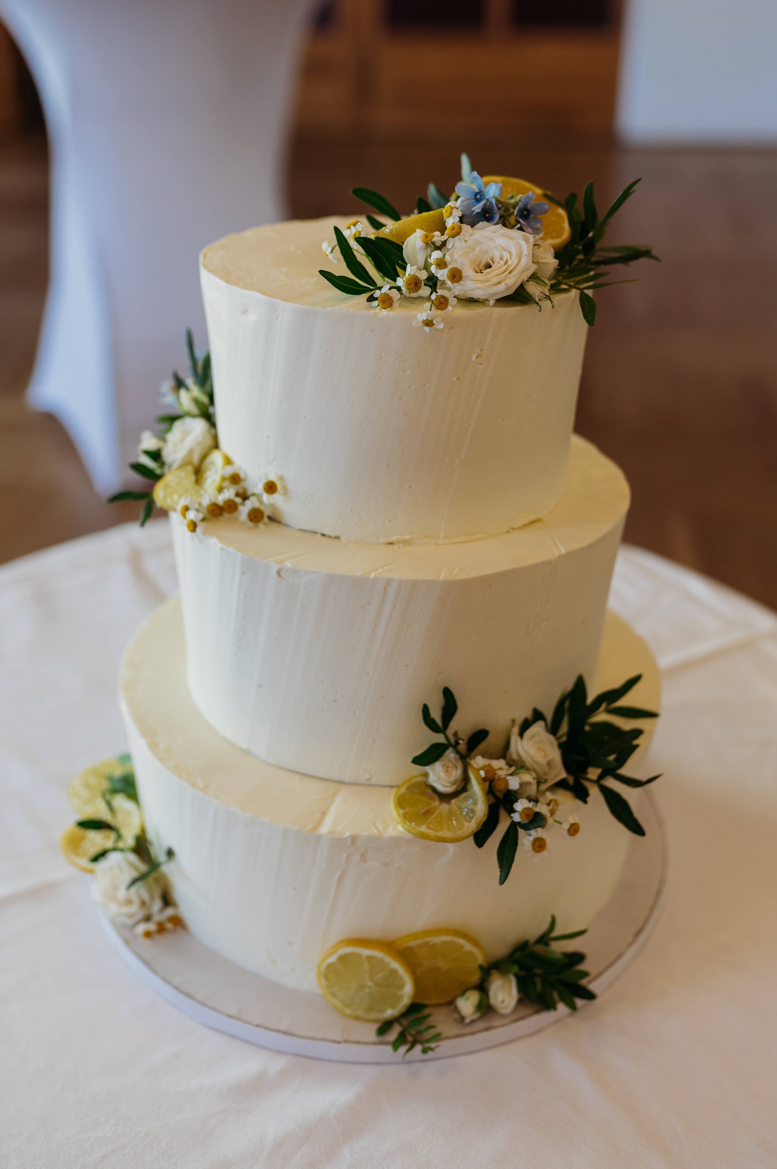 Nádherný patrový svatební dort zdobený živými květy jako sladká tečka dokonalého svatebního dne. Třípatrový dort s citróny.