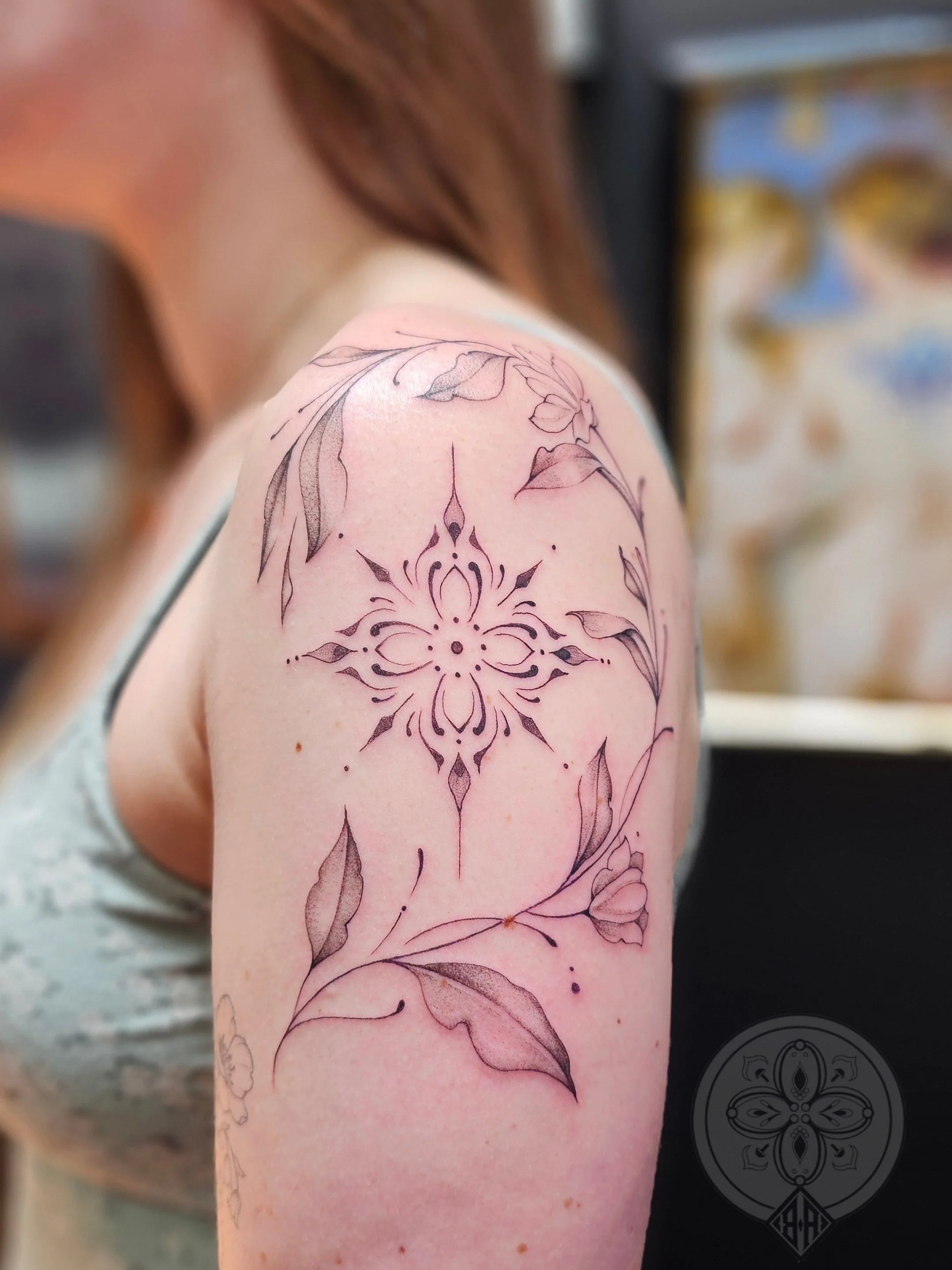 Fineline floral and ornamental bicep tattoo